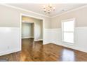 Dining room with beautiful wainscoting, hardwood floors, and natural light at 1700 Cobblefield Cir, Dacula, GA 30019