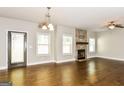 Bright living room with hardwood floors, recessed lighting, and a stone fireplace at 1700 Cobblefield Cir, Dacula, GA 30019