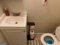 Cozy bathroom with a white vanity, toilet, and neutral wall color at 6935 Oakhill Cir, Austell, GA 30168