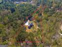 Aerial view of the home with a spacious lot, surrounded by lush greenery and mature trees at 671 Ellison Rd, Tyrone, GA 30290