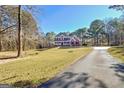 Charming two-story home with a welcoming front porch and a well-manicured lawn at 671 Ellison Rd, Tyrone, GA 30290