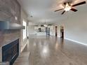 Open concept living space with modern fireplace, hardwood flooring, and seamless flow into the kitchen at 1820 Cobblefield Cir, Dacula, GA 30019