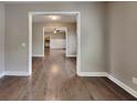 Inviting living room showcasing hardwood floors, neutral paint, and seamless flow into other areas at 1820 Cobblefield Cir, Dacula, GA 30019