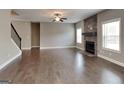 Bright and spacious living room with hardwood flooring, fireplace, and staircase at 1820 Cobblefield Cir, Dacula, GA 30019
