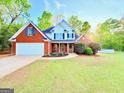 Lovely brick home with a two-car garage and colorful landscaping at 515 Sherwin Ct, Mcdonough, GA 30252
