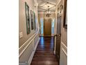Inviting foyer featuring hardwood floors, stylish lighting, and decorative wall art at 1581 Shetland Pony Nw Ct, Suwanee, GA 30024