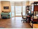 Bright home office with a large bay window, hardwood floors, and ample workspace at 1581 Shetland Pony Nw Ct, Suwanee, GA 30024