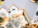 Aerial view of a home showcasing an attached garage, a well manicured lawn, and mature trees at 1252 Heritage Dr, Villa Rica, GA 30180
