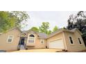 Inviting traditional home featuring a two-car garage and mature landscaping at 1252 Heritage Dr, Villa Rica, GA 30180