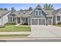 Charming blue two-story home with a well-manicured lawn and a two-car garage at 608 White Cedar Ct, Peachtree City, GA 30269