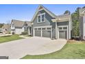 Three-car garage with a wide driveway and well-maintained landscaping at 608 White Cedar Ct, Peachtree City, GA 30269