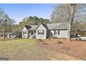 Ranch-style home with light gray exterior, complemented by a carport and well-maintained landscaping at 100 Rockland Trl, Sharpsburg, GA 30277