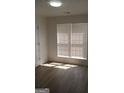 Sunlit bedroom with new flooring, fresh paint, and large window at 349 Saratoga Pl, Riverdale, GA 30296