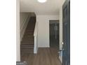 Inviting entryway with stairs and views into a large open living area with new flooring at 349 Saratoga Pl, Riverdale, GA 30296