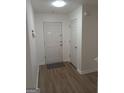 Bright hallway featuring new flooring, fresh paint, and access to multiple rooms at 349 Saratoga Pl, Riverdale, GA 30296