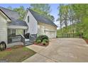 Attached garage and outdoor area with landscaping and a fenced-in entrance at 225 Mapledale Trl, Sharpsburg, GA 30277