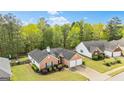 Single Gathering home featuring an attached garage and a well-kept lawn at 11970 Fairway Overlook, Fayetteville, GA 30215