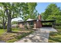 Single-story brick home featuring a covered carport and long concrete driveway at 264 Rockin Hill Sw Dr, Marietta, GA 30060