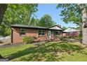 Cozy brick home with well-kept lawn, mature trees and a covered porch at 264 Rockin Hill Sw Dr, Marietta, GA 30060