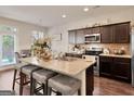 Gourmet kitchen features a large kitchen island with barstool seating and stainless steel appliances at 11755 Lovejoy Crossing Blvd, Hampton, GA 30228
