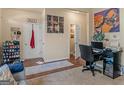 This office space features dark hardwood floors and unique artwork, with a work station in the corner at 11755 Lovejoy Crossing Blvd, Hampton, GA 30228