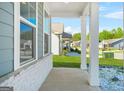 Covered porch showing brick column bases with view of lawn and community at 790 Riverwood Pass, Dallas, GA 30157