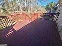 Spacious, stained-wood outdoor deck with railings at 222 Flat Creek Ct, Peachtree City, GA 30269