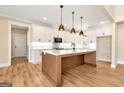 Bright, modern kitchen with white cabinets, a center island, and stainless steel appliances at 4711 H D Atha Rd, Covington, GA 30014