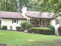 Charming home featuring a covered front porch and meticulously landscaped garden at 15 Perthshire Dr, Peachtree City, GA 30269