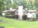 Attractive home showcasing a well-maintained lawn and decorative shrubbery in the front yard at 15 Perthshire Dr, Peachtree City, GA 30269