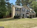 Traditional two-story home with stone accents and mature trees in a quiet, wooded neighborhood at 3999 Cumberland Se Trl, Conyers, GA 30094