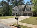 Beautiful two-story home with a brick and siding exterior, a well-manicured lawn, and a two-car garage at 3999 Cumberland Se Trl, Conyers, GA 30094