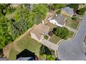 Aerial view of the house with a well-maintained lawn and a circular driveway at 1275 Mill Shyre Way, Lawrenceville, GA 30043