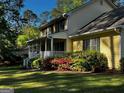 Charming yellow home with beautiful landscaping and a welcoming front porch at 140 Julie Rd, Tyrone, GA 30290