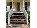 Inviting front entrance with classic wooden door, decorative wreath and stairs leading up to porch at 140 Julie Rd, Tyrone, GA 30290