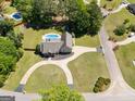 Aerial view of a private backyard featuring a swimming pool and a circular driveway at 207 Jamestown Ave, Jonesboro, GA 30236