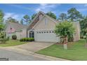 Home exterior featuring a two-car garage, tasteful landscaping, and a concrete driveway at 203 Collierstown Way, Peachtree City, GA 30269