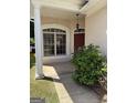 Inviting front porch with a large window, red front door, and a column on the left at 203 Collierstown Way, Peachtree City, GA 30269
