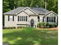 Well-maintained single-story home with a manicured lawn and a welcoming front door at 5930 Shannon Dr, Cumming, GA 30040