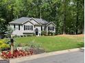 Beautiful single-story home with lush green lawn, flower beds, and a charming mailbox at 5930 Shannon Dr, Cumming, GA 30040