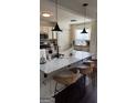 Bright, eat-in kitchen featuring a granite island, pendant lights, and seating for three at 5930 Shannon Dr, Cumming, GA 30040