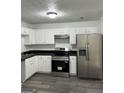 Modern kitchen featuring stainless steel appliances, white cabinets, and sleek countertops at 5041 Cottage Grove Pl, Union City, GA 30291