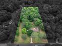 Aerial view of a wooded property with mature trees and a single-story home at 1710 Crumbley Rd, Mcdonough, GA 30252