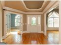 Elegant foyer featuring hardwood floors, detailed trim work, and a decorative front door with sidelights at 1270 Tribble Walk Ct, Lawrenceville, GA 30045