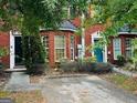 Brick townhome with bay window, neat landscaping, and a colorful blue front door at 2698 Norfair Loop, Lithonia, GA 30038