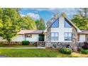 Inviting home exterior with a stone facade, a gable roof, and a lush green lawn at 3222 Bay View Dr, Jonesboro, GA 30236