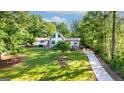 Spacious property showcasing a charming home with mature trees and a long driveway at 3222 Bay View Dr, Jonesboro, GA 30236