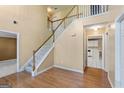 Foyer with hardwood floors and staircase leading to the second floor at 643 Rangeley Meadows Ct, Hampton, GA 30228
