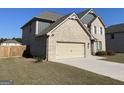 Two-story brick home with a two car garage and a concrete driveway at 169 Cabin Way, Hampton, GA 30228
