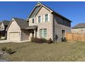 Charming two-story brick home with landscaped yard, two-car garage and a well maintained lawn at 169 Cabin Way, Hampton, GA 30228